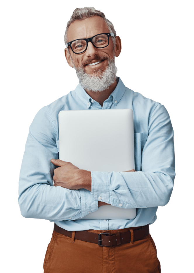 Mature professional man with glasses and white beard holding closed laptop against chest.